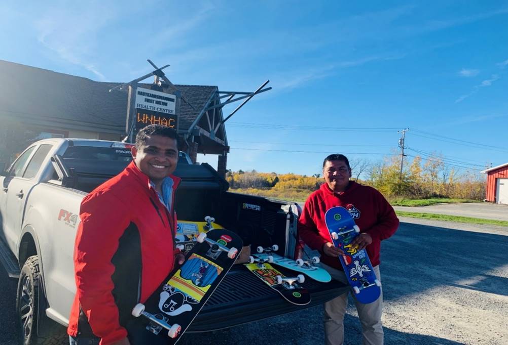 Grand Council Treaty# 3 Youth Coordinator Johnpaul George (L) and Naotkamegwanning Youth Worker Roman Naymaypoke (R) on the event of the skateboard donation to the community.