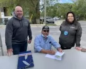 Erik Holmstrom Vice President of Miitigoog (left), Wabauskang Chief Bill Petiquan (middle), Miitigoog President Lorraine Cobiness (right), signing the agreement welcoming Wabauskang to the partnership.